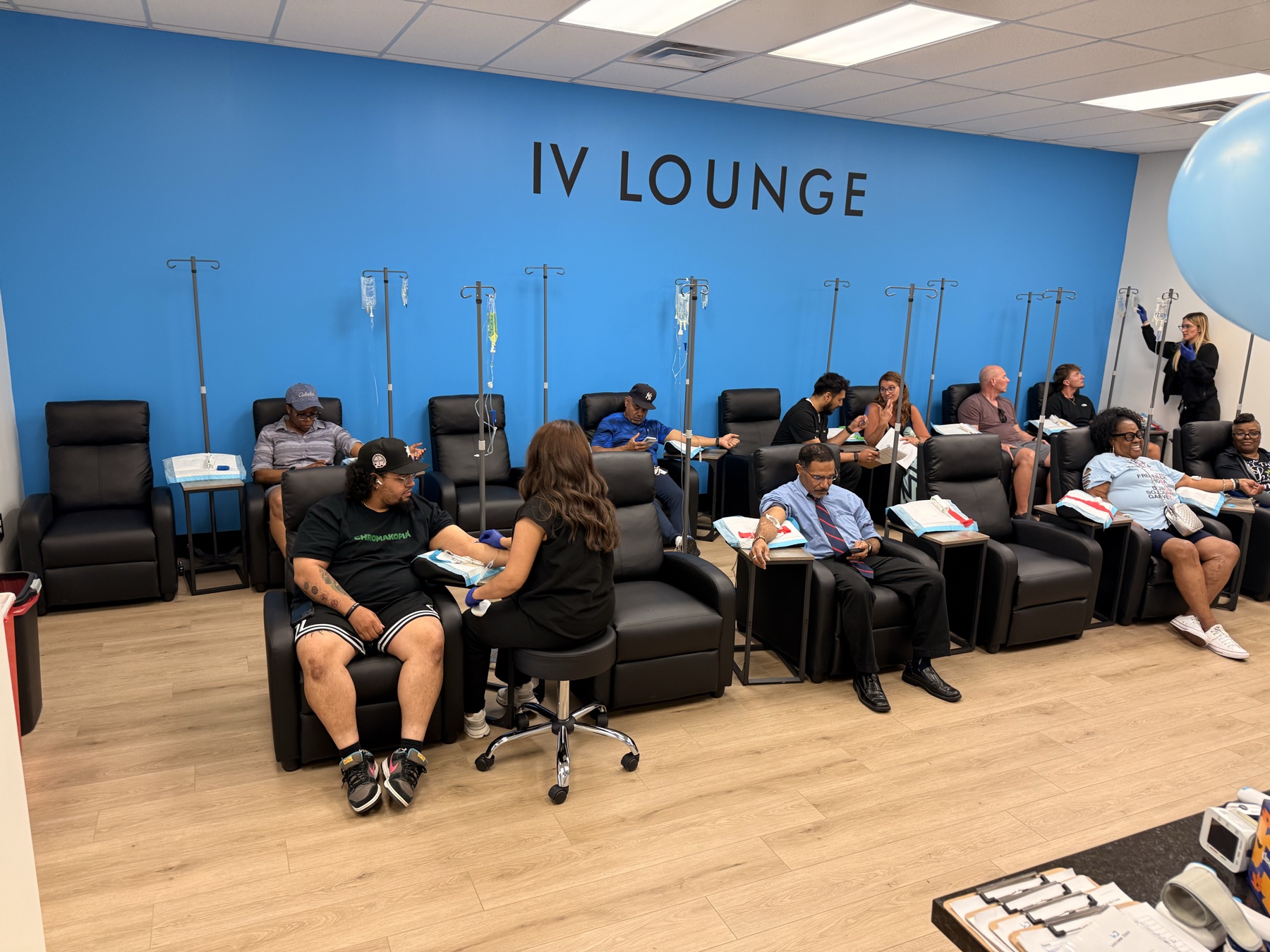 The IV Lounge full of guests receiving free vitamin IVs